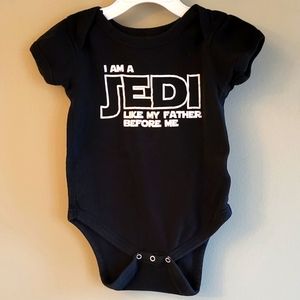 Black onesie/bodysuit with Star Wars reference